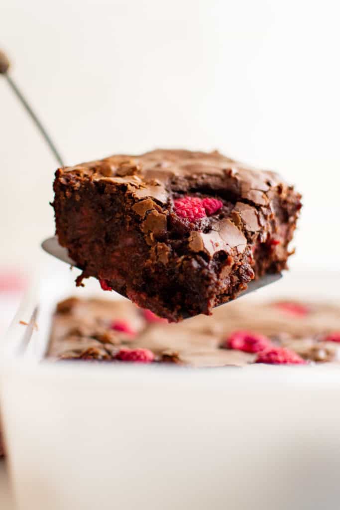 Raspberry brownie on a spatula.