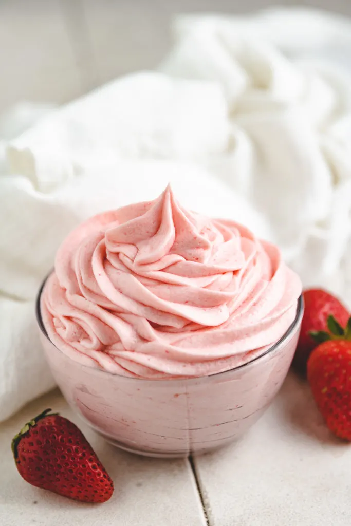 Swirls of strawberry buttercream frosting in a dish.