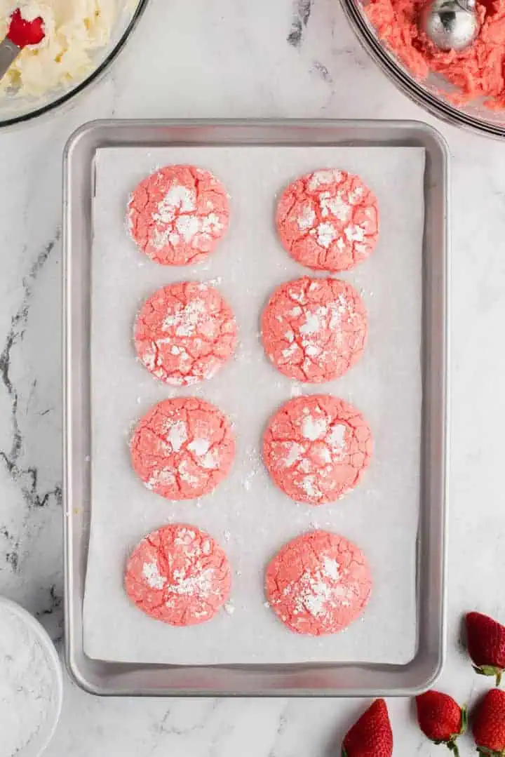 Strawberry cake mix cookies on a sheet pan.
