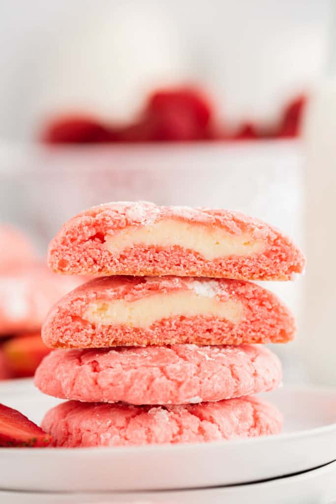 Cream cheese strawberry cookies cut in half.