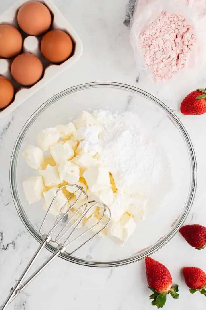 Cream cheese and powdered sugar in a bowl.