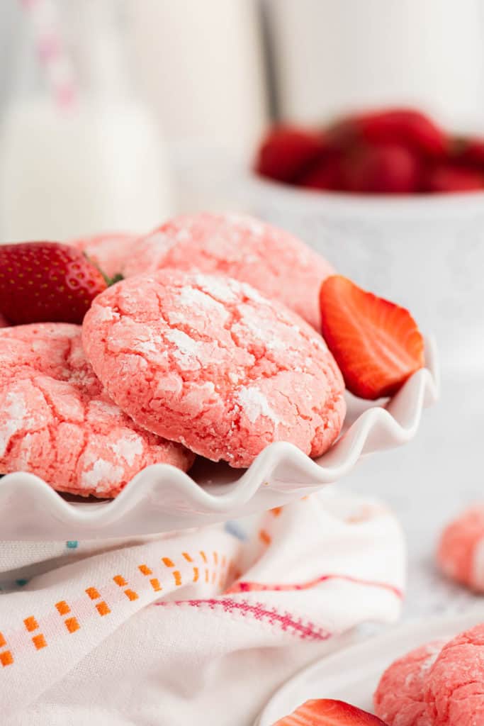 Strawberry cookies on a ruffled plate.