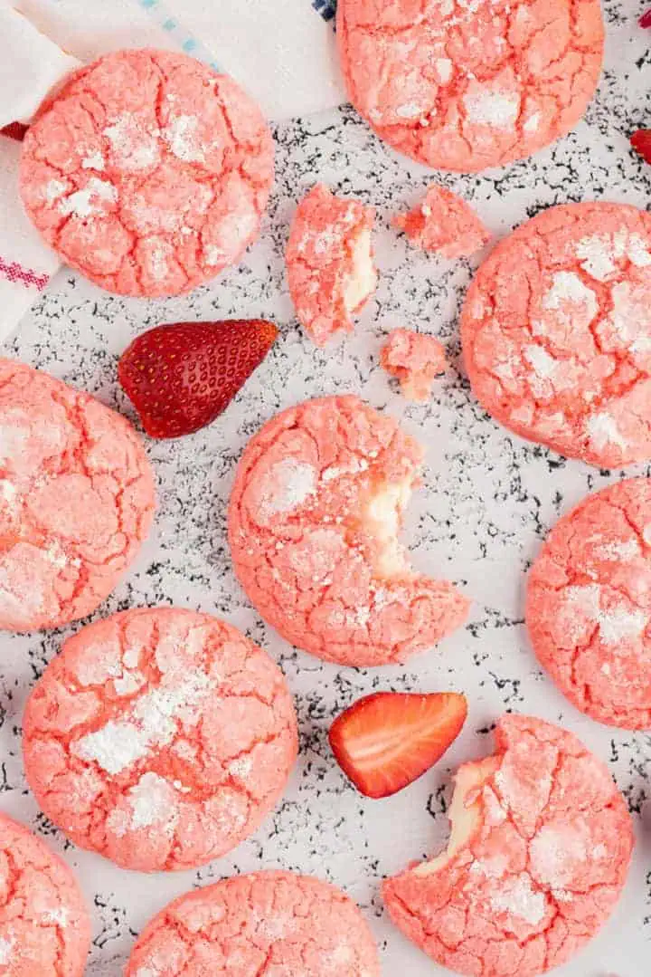 Bite taken out of a strawberry cookie.