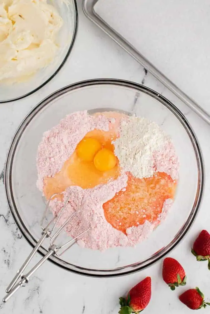 Eggs, cake mix, flour and butter in a bowl.