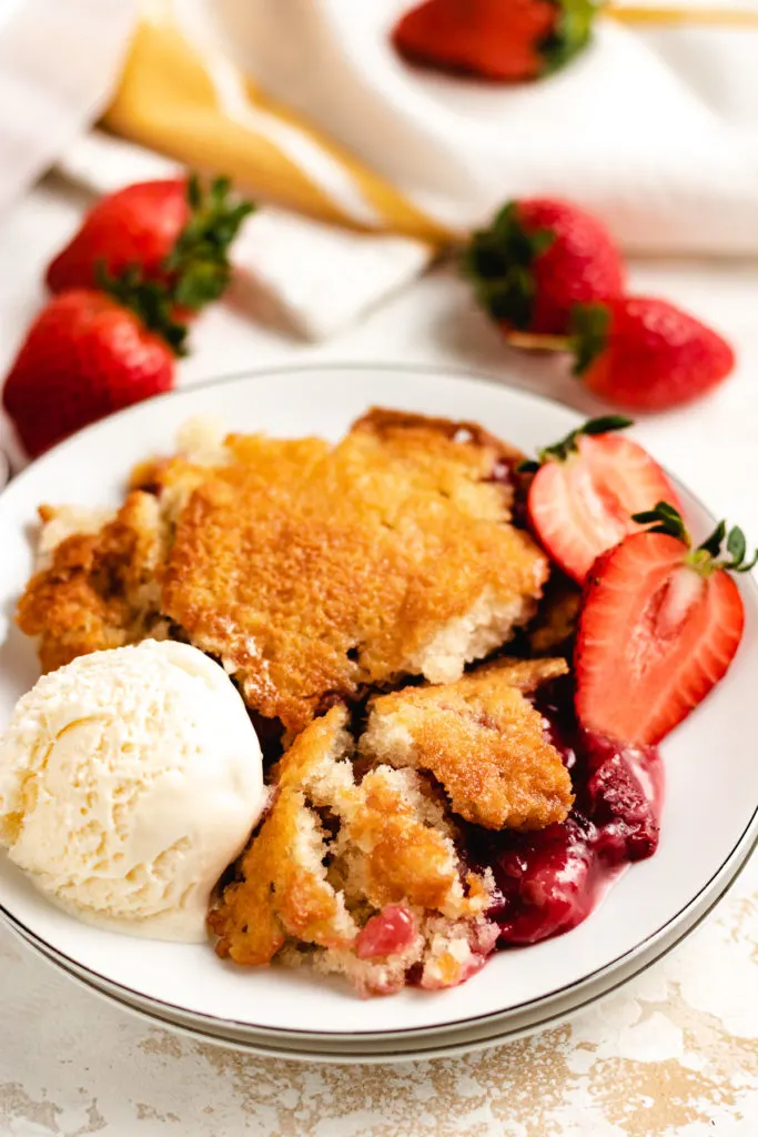 Top down view of strawberry cobbler on a plate.
