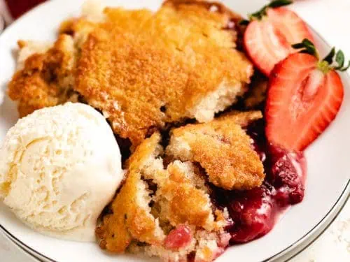 Top down view of strawberry cobbler on a plate.