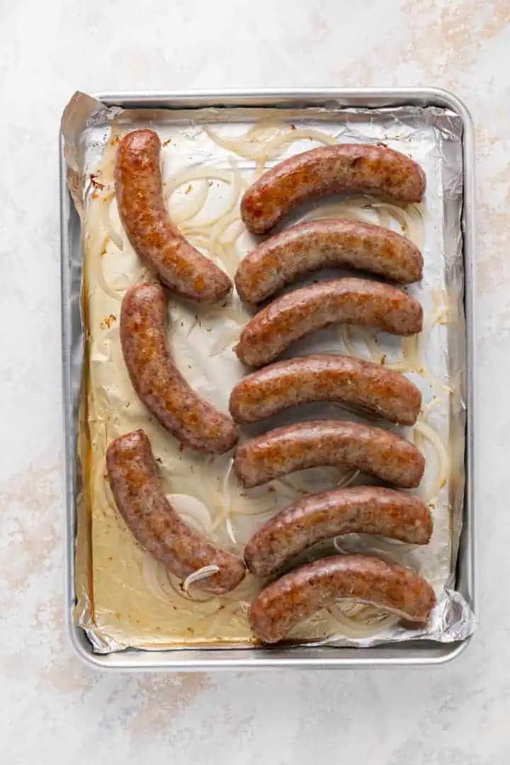 Baked brats on a sheet pan.