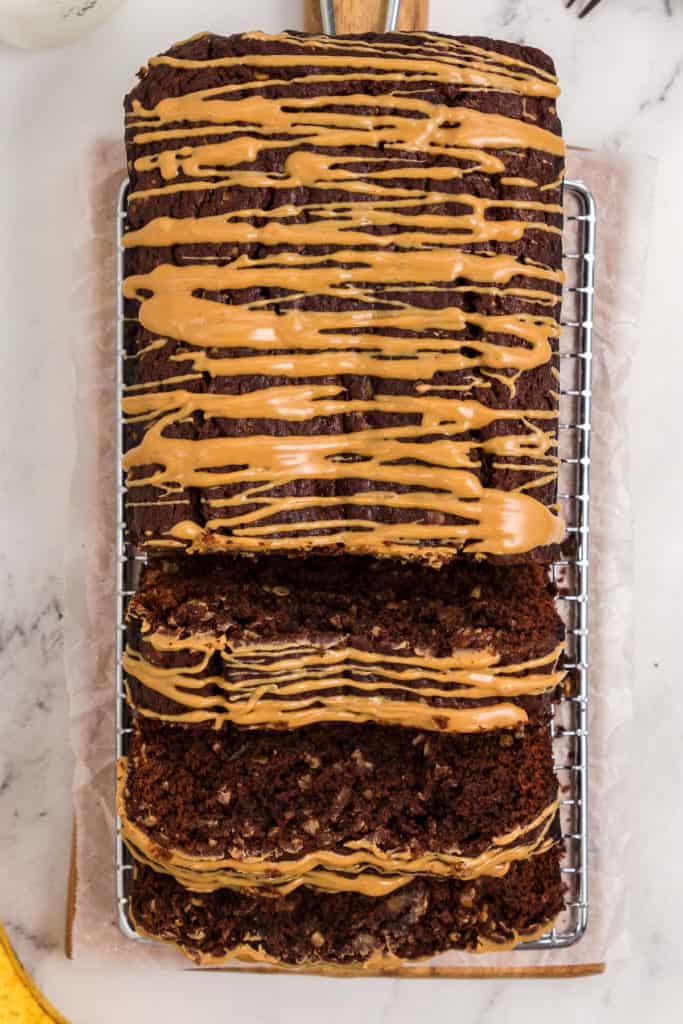 Sliced chocolate banana bread drizzled with peanut butter.