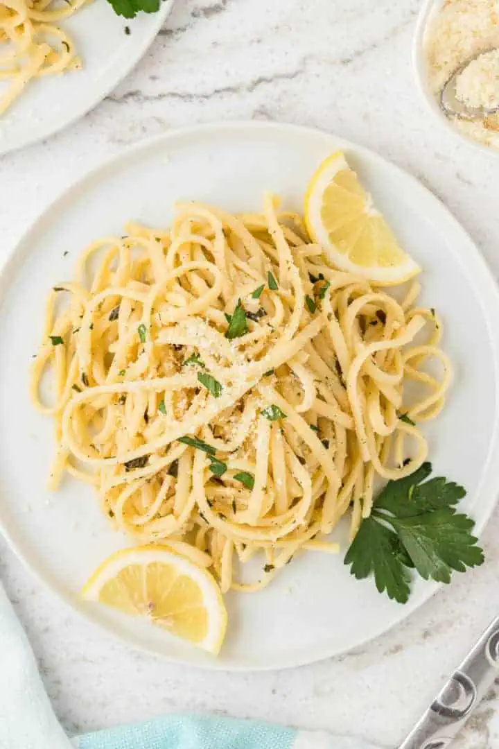 Top down view of pasta with lemon on a plate.