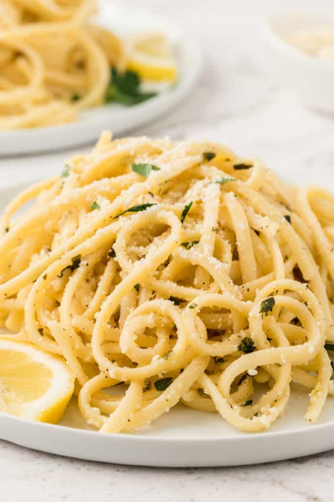 Close up view of pasta with lemon and cheese.