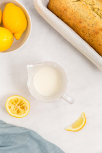 Lemon glaze in a measuring cup.