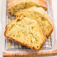 Sliced loaf of lemon bread on a cutting board.