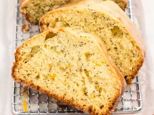 Sliced loaf of lemon bread on a cutting board.