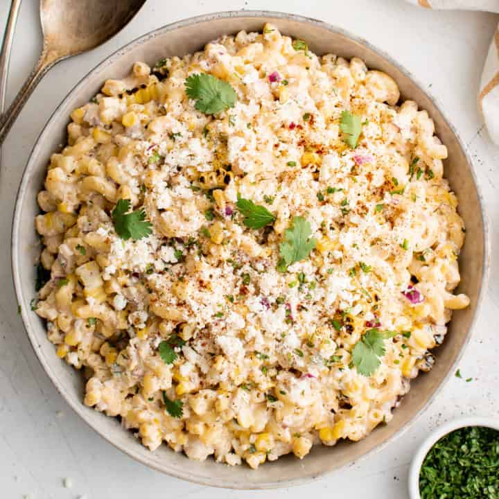 Top down view of mexican street corn pasta salad in a serving dish.