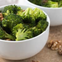Close up view of oven roasted broccoli in a bowl.