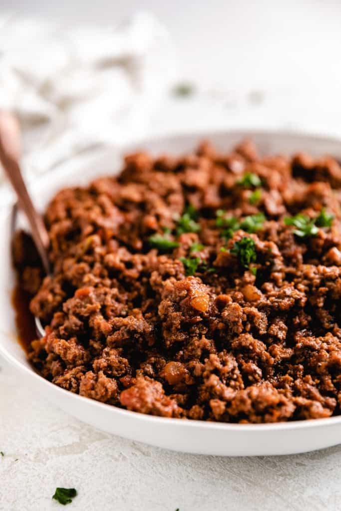 Side view of seasoned ground beef in a bowl.