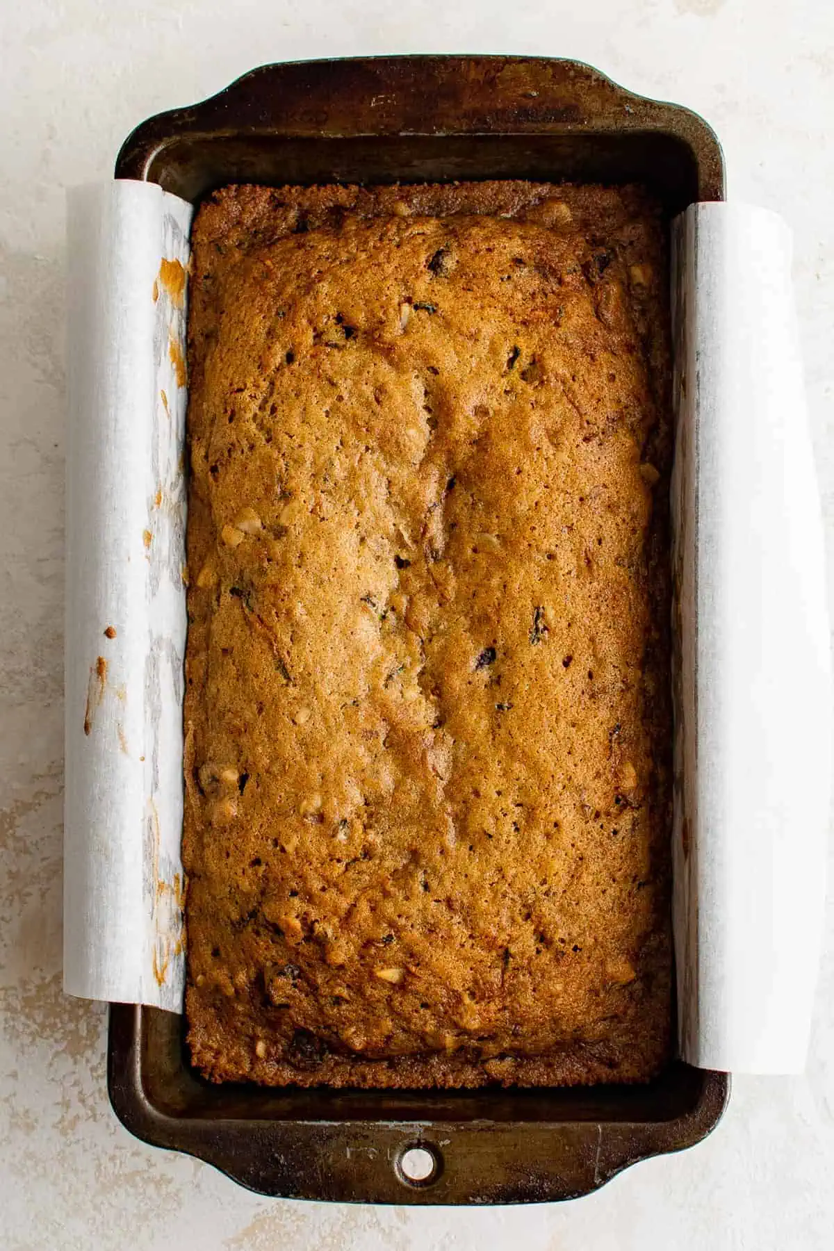 Baked zucchini bread in a loaf pan.
