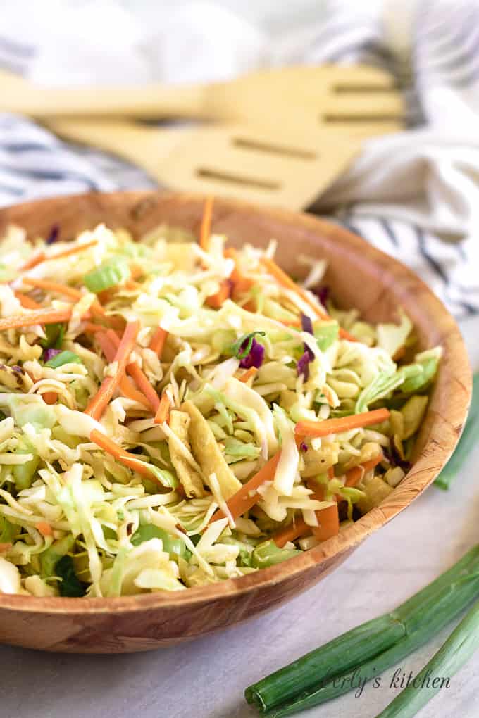 Wooden bowl filled with crunchy cabbage salad.