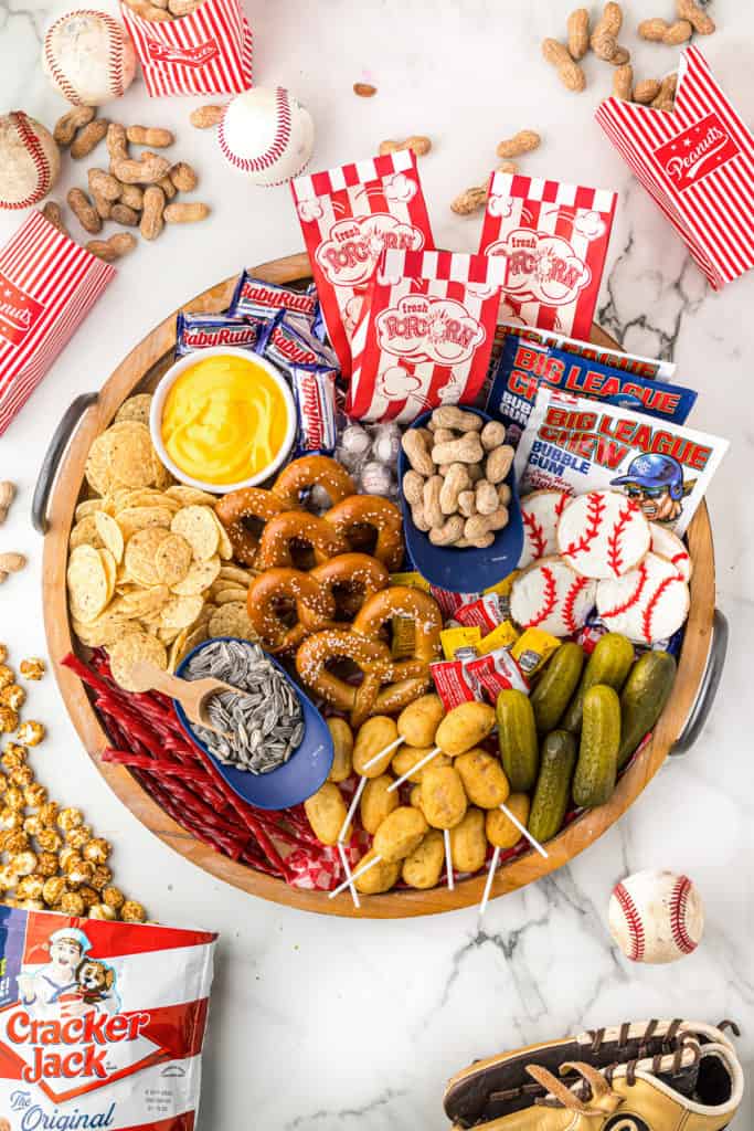 Baseball themed snacks on a board.