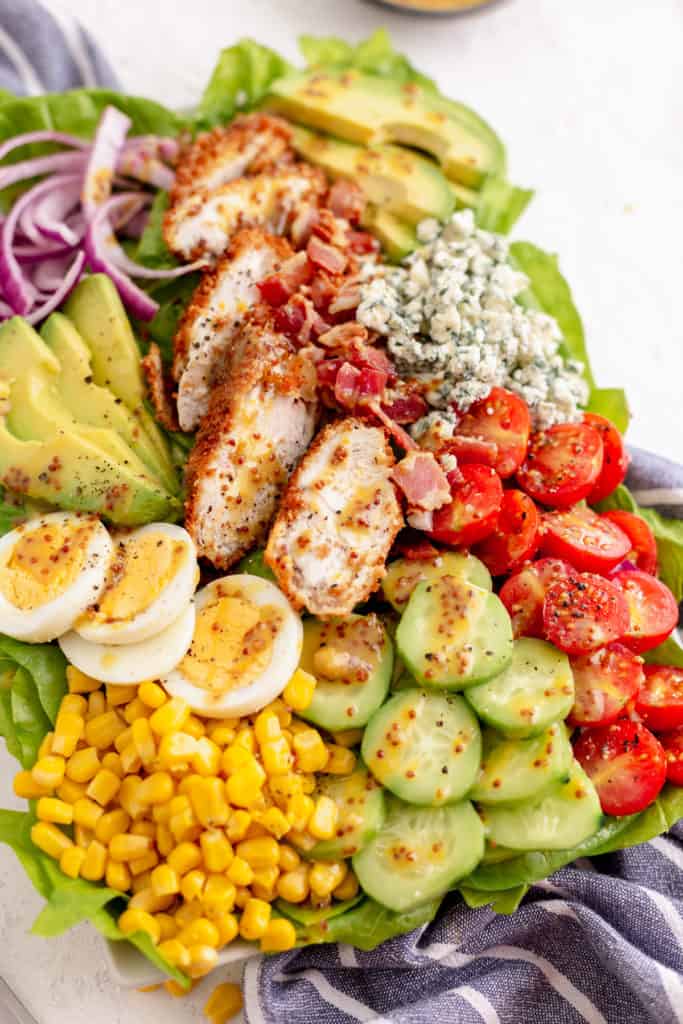 Cobb salad with crispy chicken and dressing.