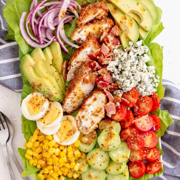 Top down view of a chicken salad with dressing.