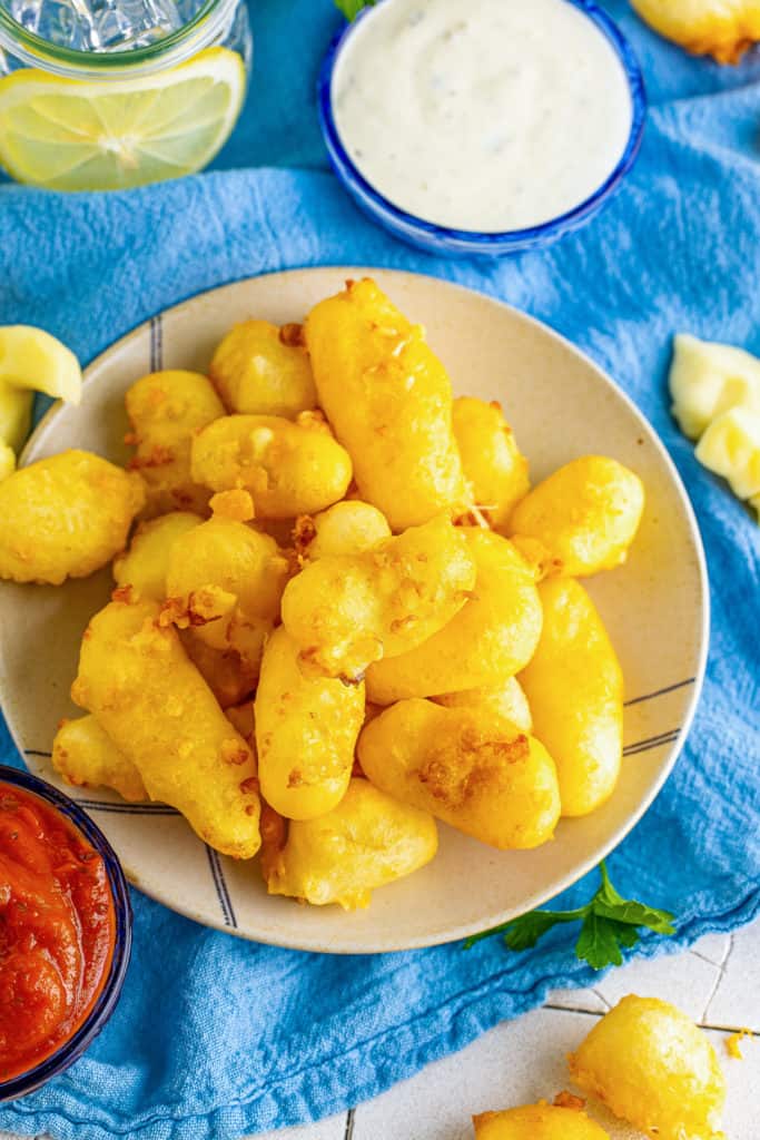 Top down view of fried cheese curds on a plate.