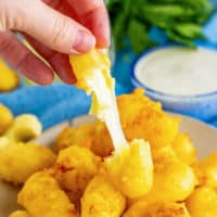 Cheese curd being pulled apart.