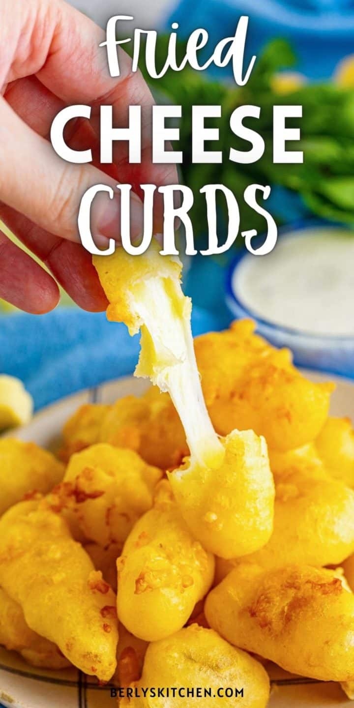 Close up view of a cheese curd being pulled in half.