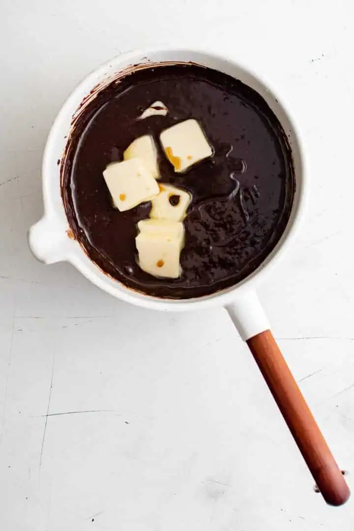 Butter added to cocoa powder and milk.