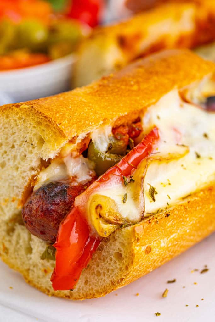 Close up of an Italian sausage and cheese sandwich.