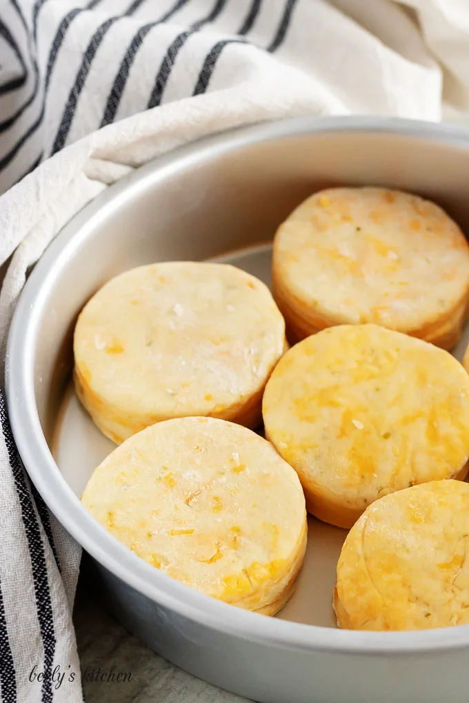 Unbaked biscuits in a pan.