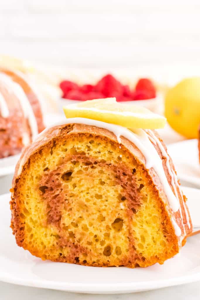 Side view of a slice of swirled lemon raspberry cake.