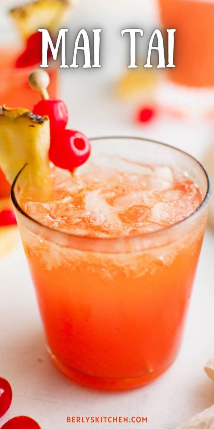 Close up view of a pink cocktail with cherries.