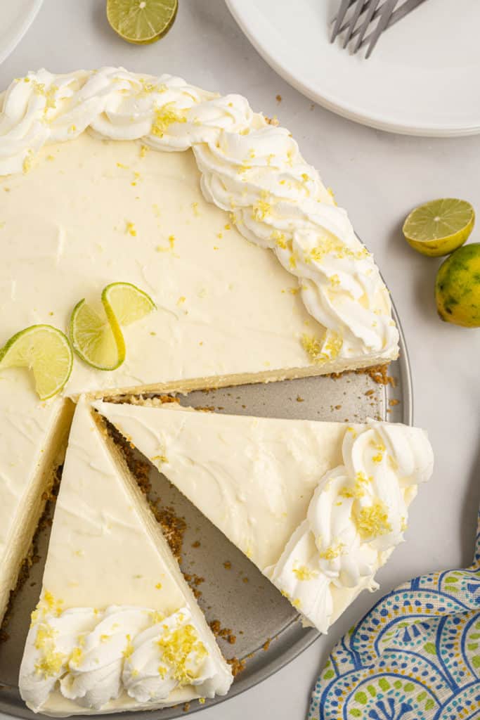 Top down view of key lime cheesecake on a platter.