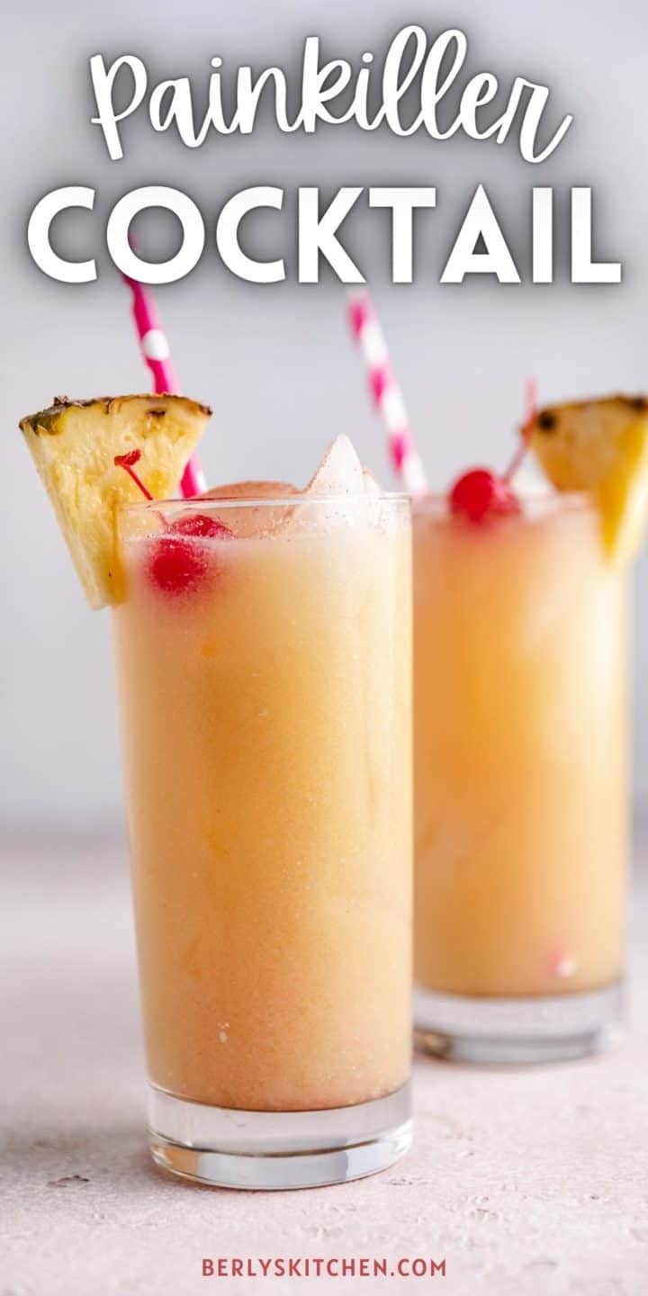 Two painkiller cocktails with pineapple wedges.