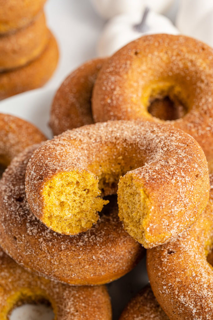 Close up view of a bite taken out of a pumpkin donut.