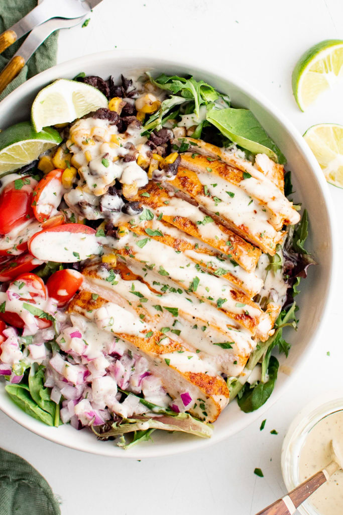 Top down view of dressing drizzled over a chicken breast.