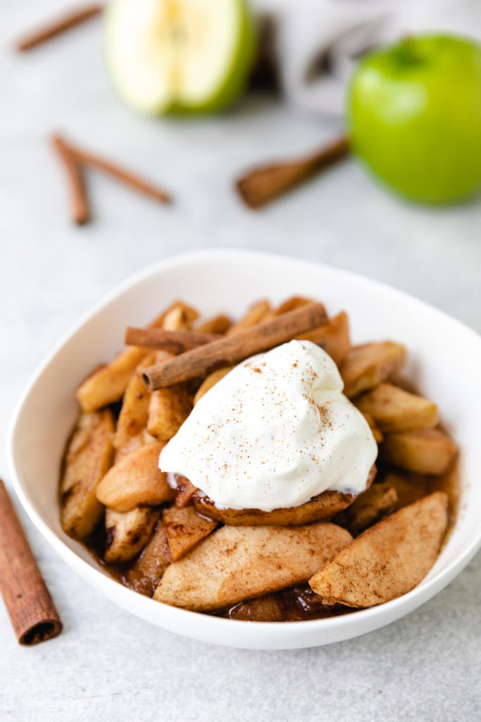 Whipped cream on top of cinnamon apples.