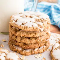Stack of iced oatmeal cookies.