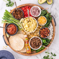 Top down view of an arrangement of foods for breakfast tacos.