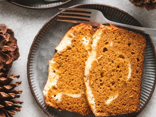 Pumpkin cream cheese bread on a metal plate.