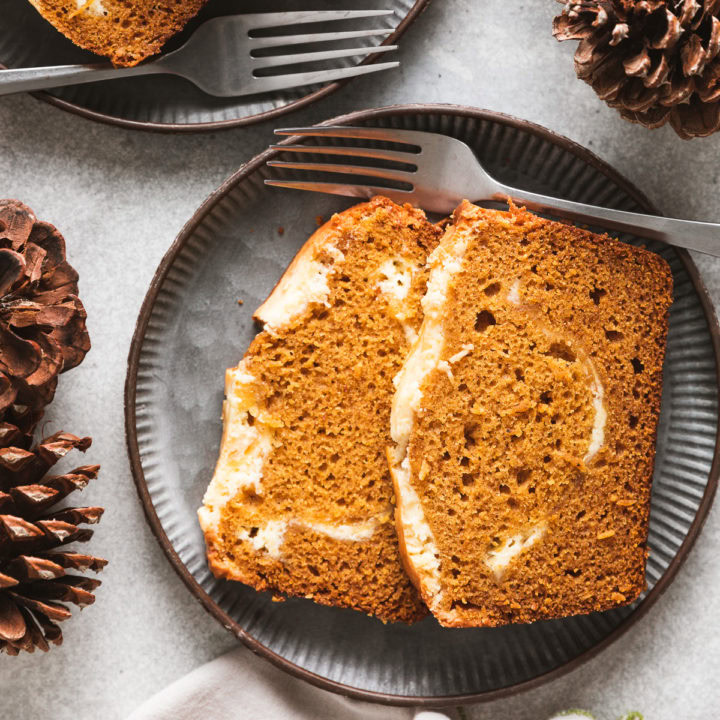 Pumpkin cream cheese bread on a metal plate.