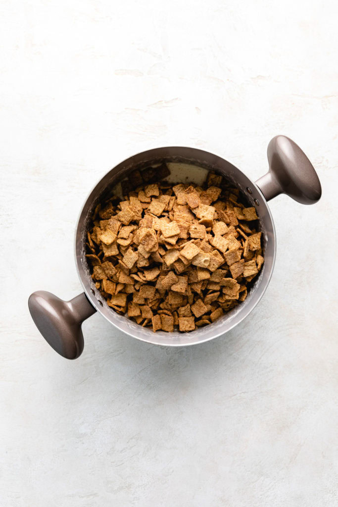 Cinnamon cereal poured on top of melted marshmallows.