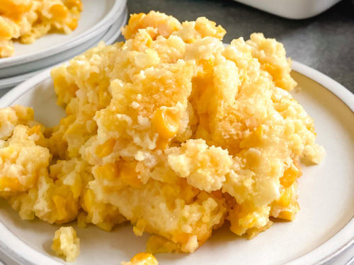 Scoop of casserole with corn on a plate.