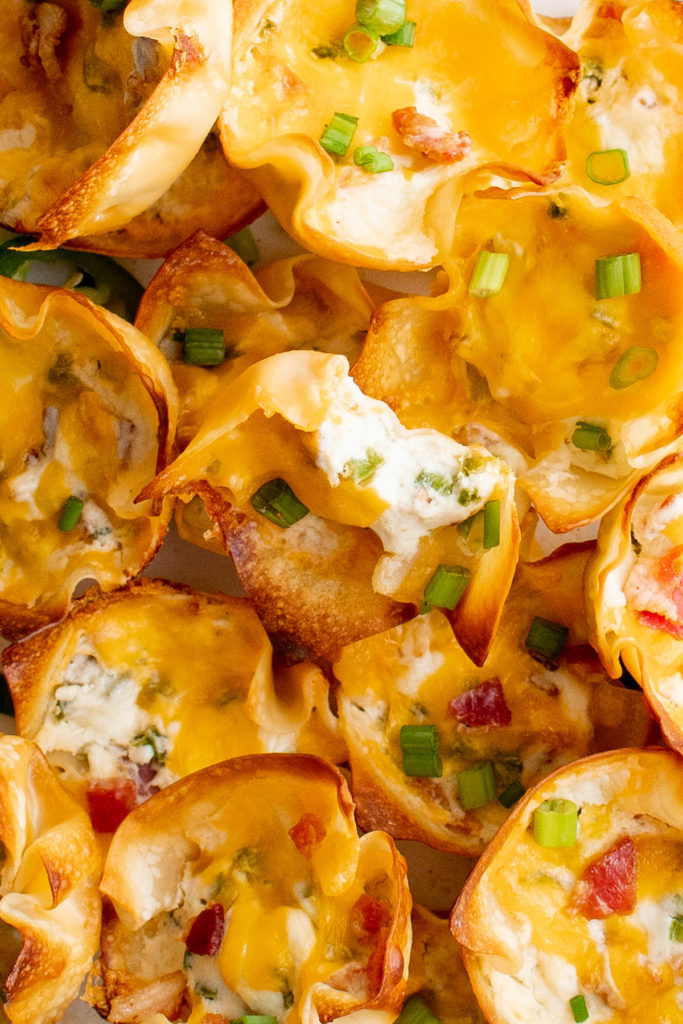 Jalapeno popper wonton cups in a pile.