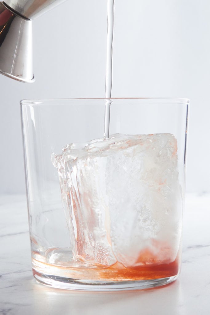 Simple syrup being poured in a glass.