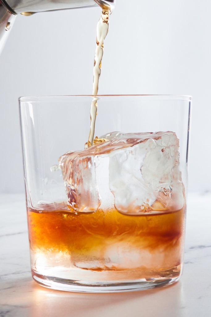 Bourbon being poured in a glass.