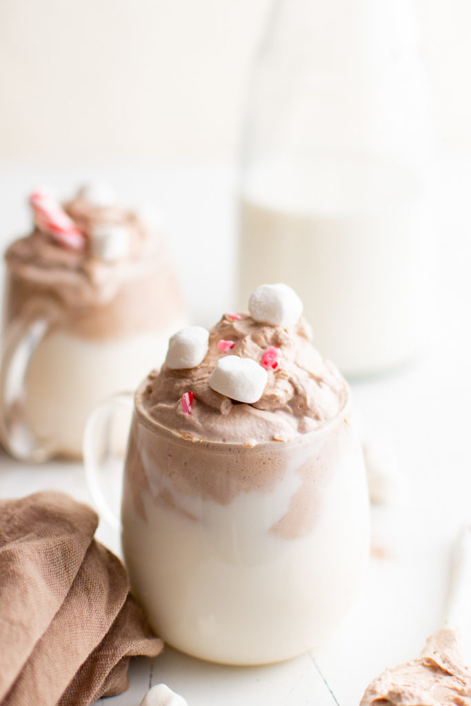 Marshmallows on top of a mug of hot chocolate.