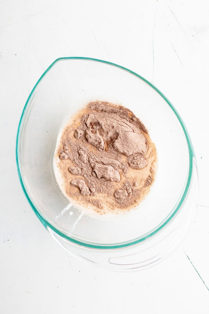 Heavy cream, hot chocolate mix and vanilla in a bowl.