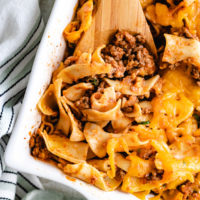 Close up view of cheesy noodle and beef casserole.